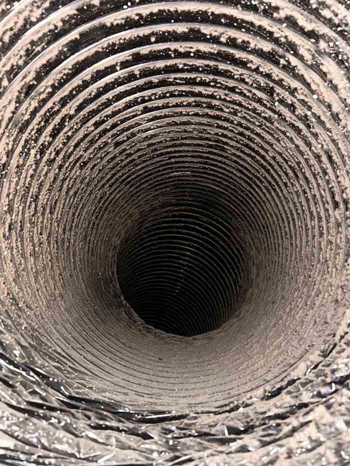 Dust in a Return Air Duct in Dallas TX Dust and debris lining a large return air duct in Dallas, TX