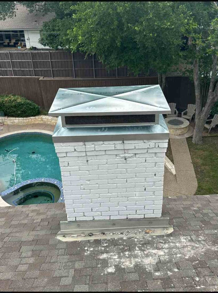 New stainless steel chimney cap installed on a repaired crown in Dallas, TX