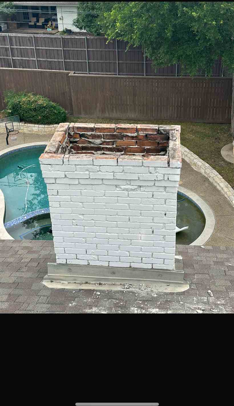 White brick chimney with a damaged crown and no cap before repair in the Dallas area