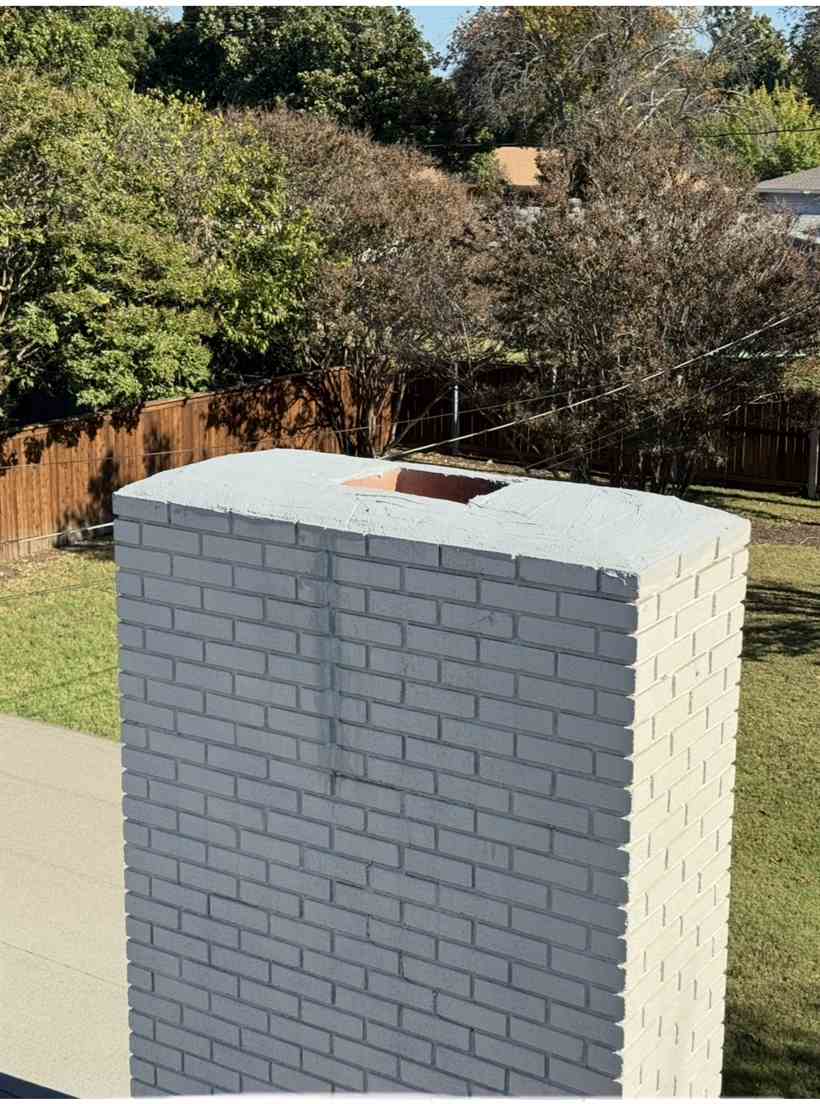 Rebuilt chimney crown on a repainted brick chimney in Dallas, TX