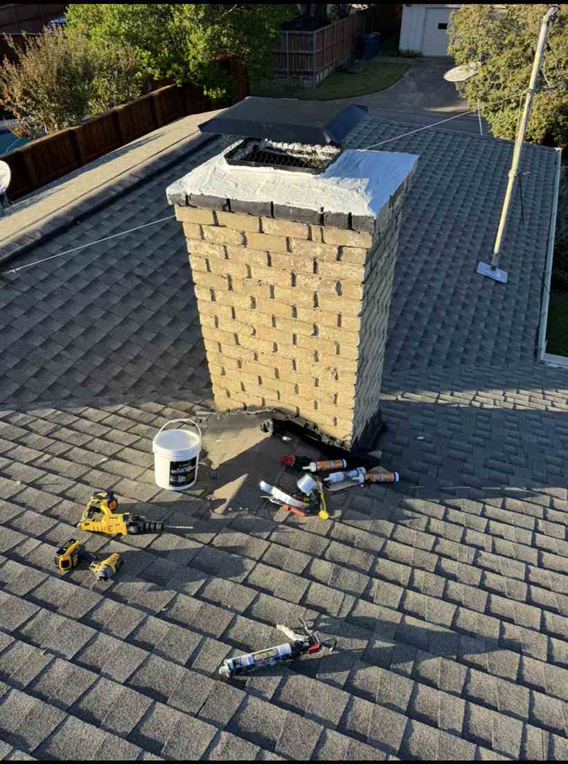 Chimney crown repair in progress with tools on a Dallas rooftop