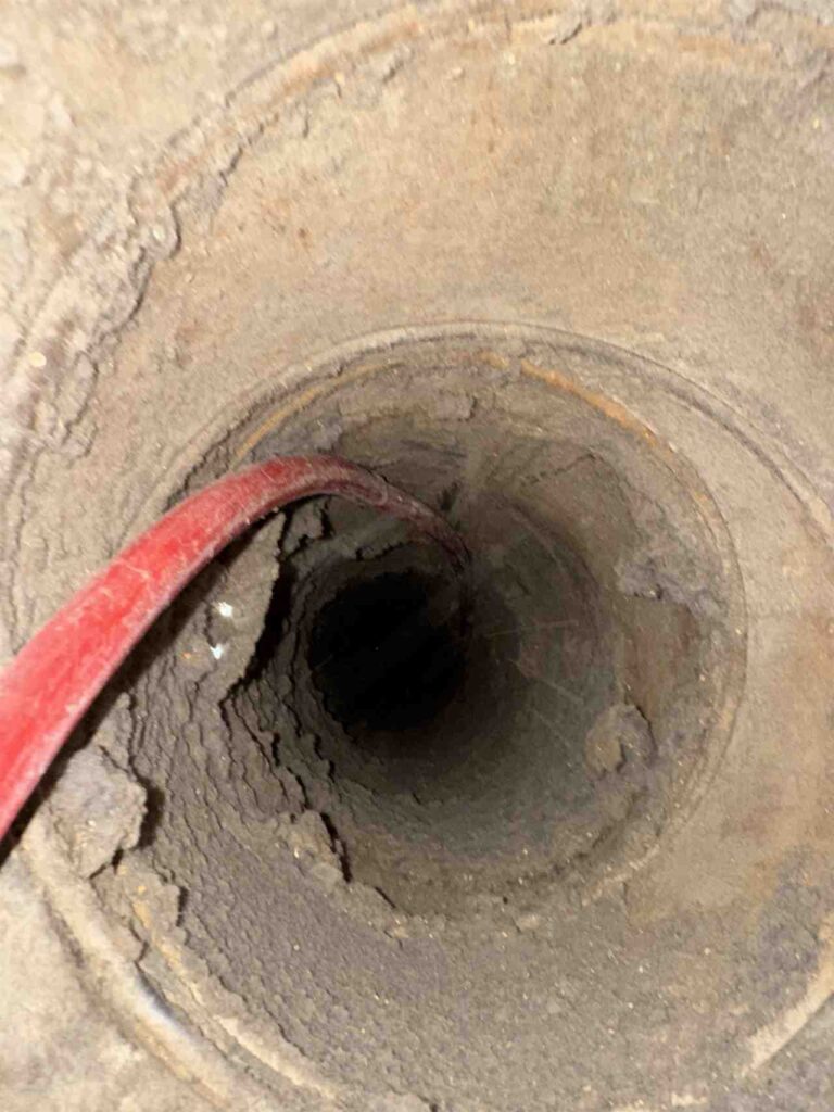 Dryer vent duct being cleaned with a compressed-air line in Dallas, TX