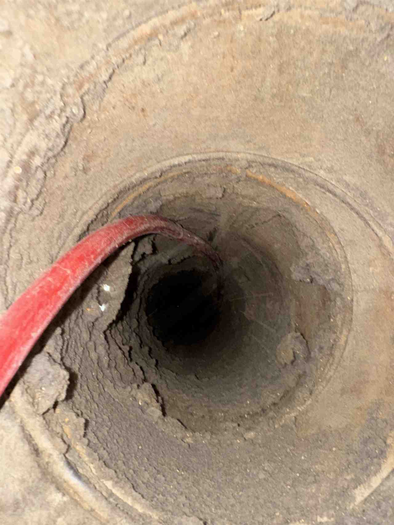 Dryer vent duct being cleaned with a compressed-air line in Dallas, TX