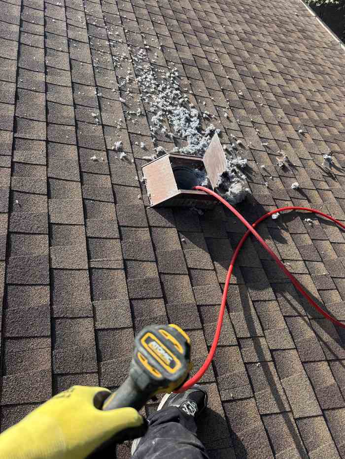 Warrior technician servicing a rooftop dryer vent in the Dallas-Fort Worth area