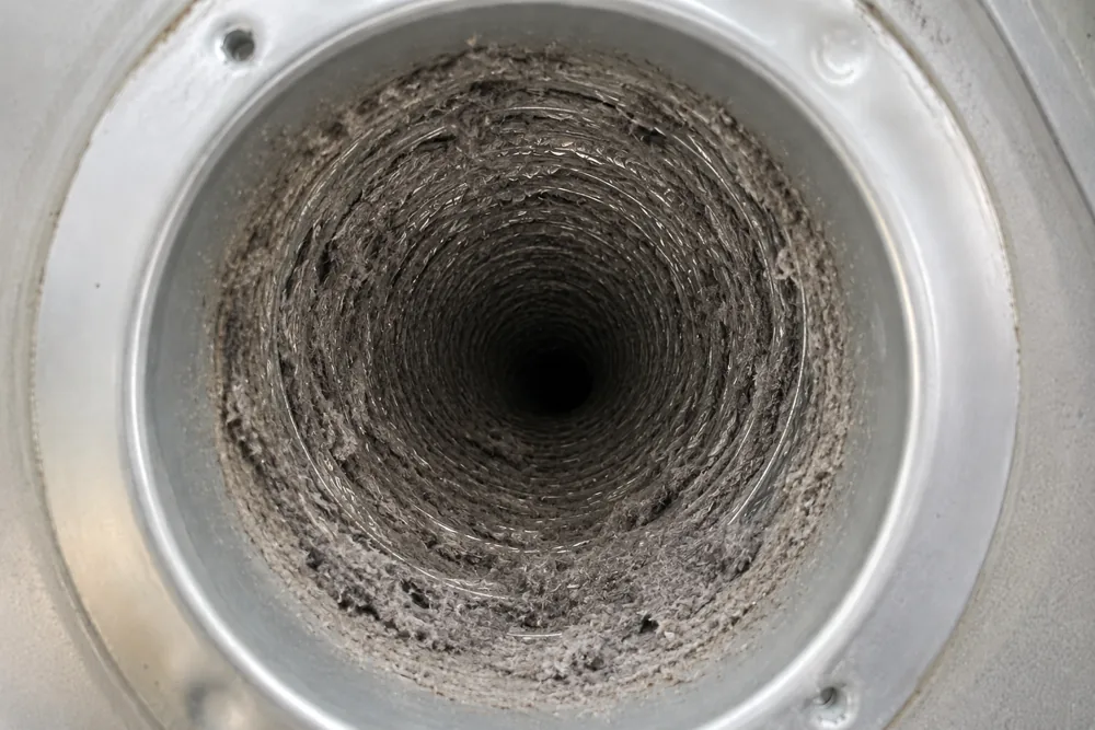 Dryer vent clogged with lint and debris before cleaning