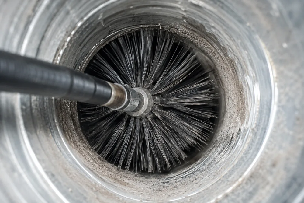 Rotating brush scrubbing the inside of a Dallas air duct during a Warrior air duct cleaning