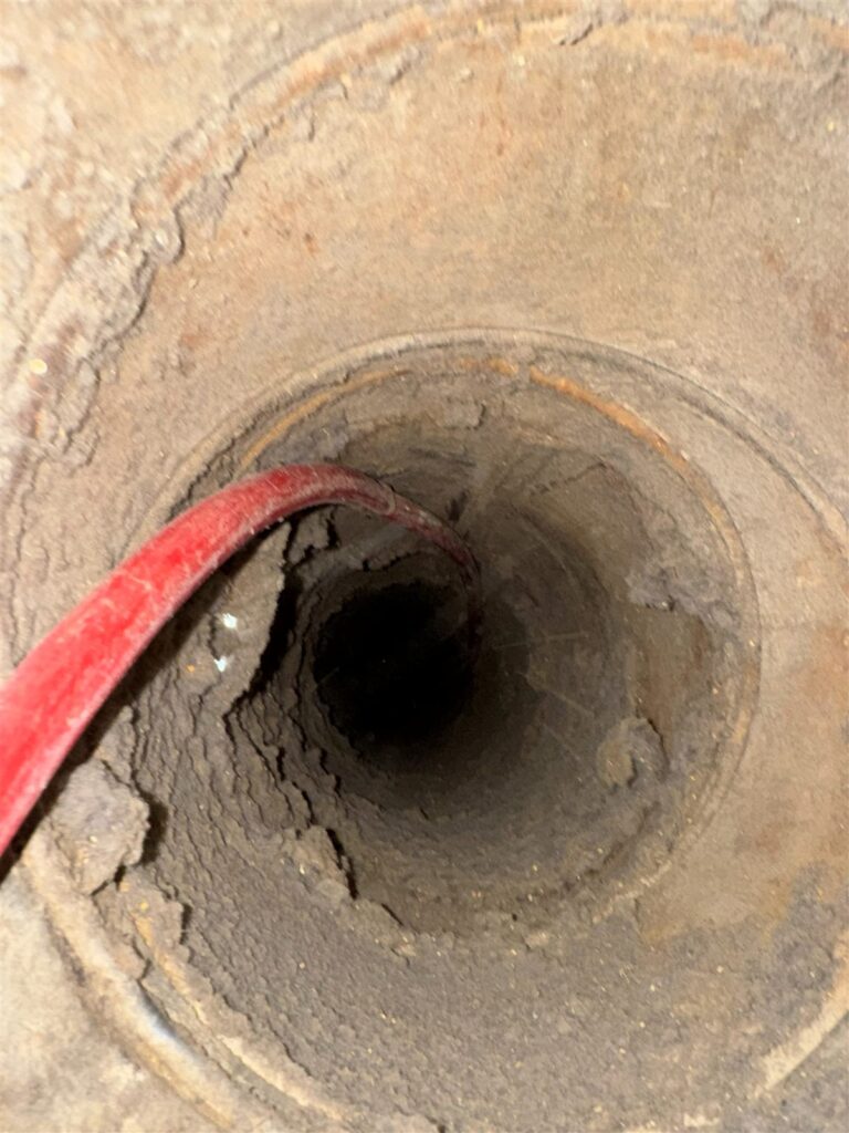 Looking down a dryer vent duct during a professional inspection in Dallas, TX