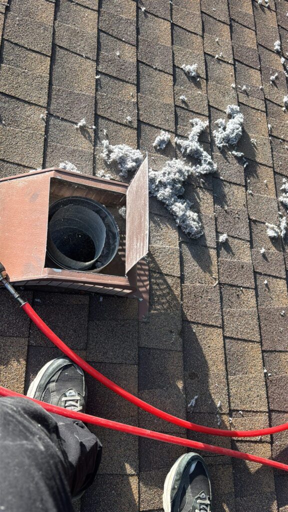 Rooftop dryer vent box during professional installation service in Dallas, TX