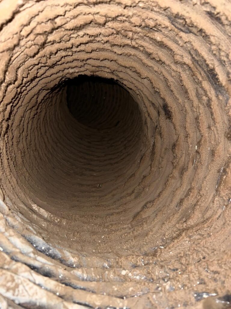 Caked dirt inside round duct, Frisco TX